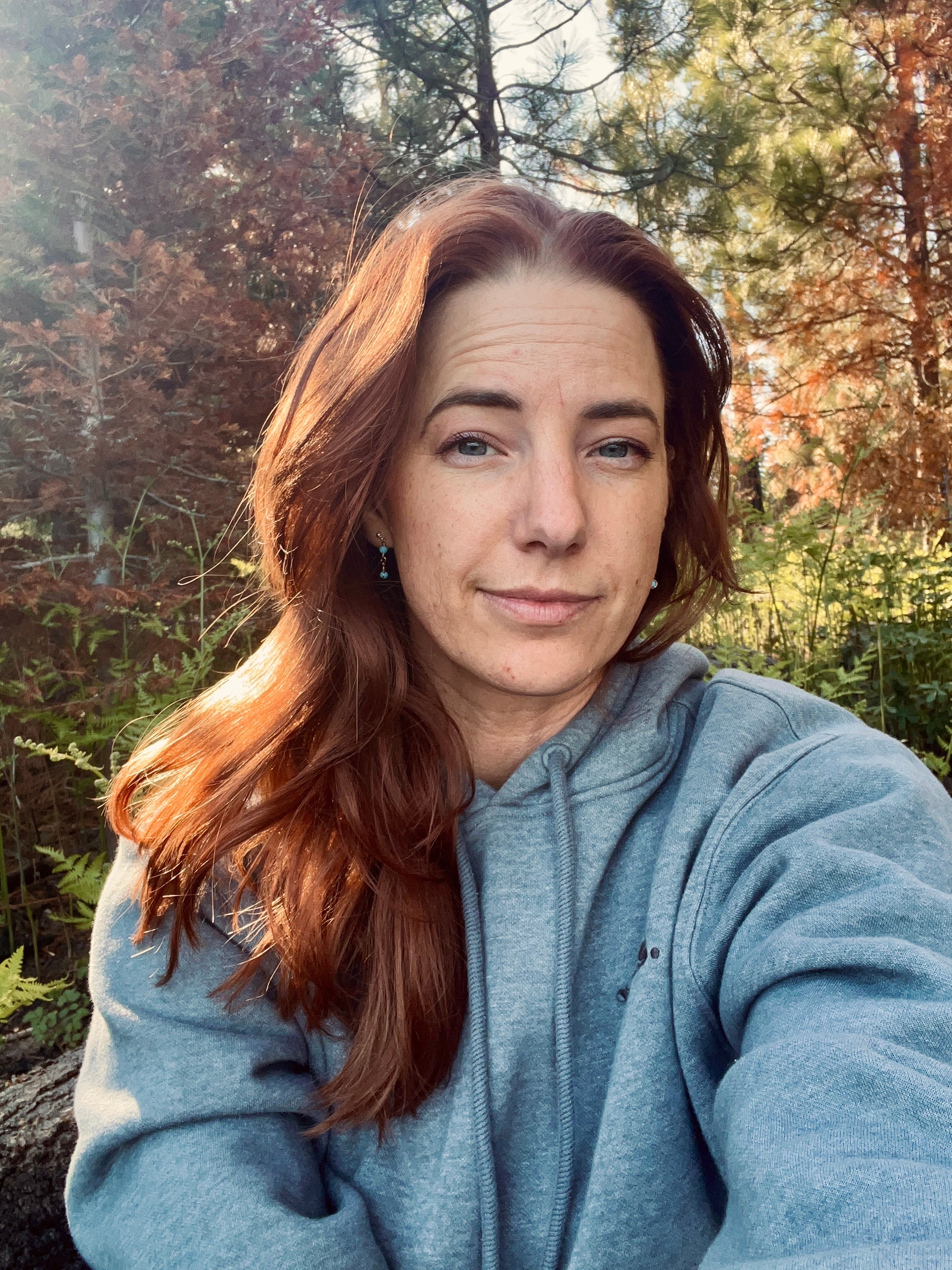 Woman taking a selfie in a forest setting